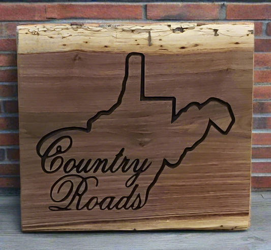 Handmade Live edge wooden sign with a map outline  of WV and 'Country Roads' text 